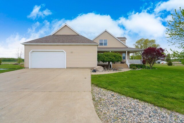 2211 N Kerby Rd, Owosso, MI 48867 - view of front of property with a front lawn, a porch, and driveway