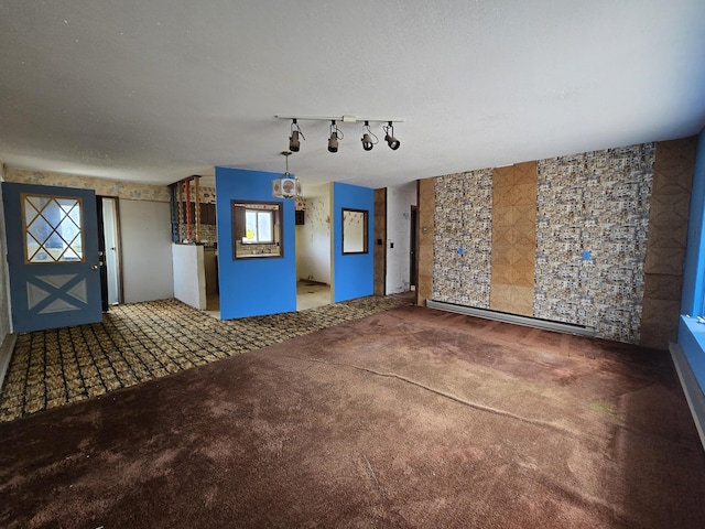 interior space featuring track lighting and carpet floors