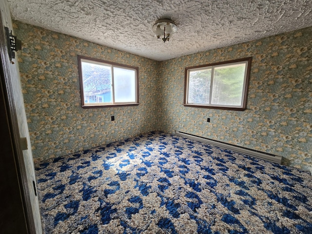 spare room with a baseboard radiator and a textured ceiling