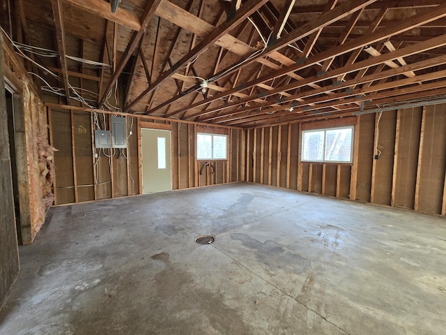 miscellaneous room featuring electric panel and a garage