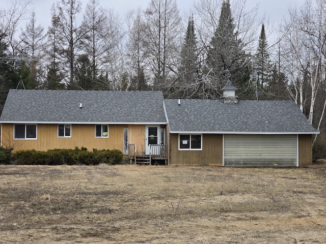 ranch-style house with a shingled roof and an attached garage