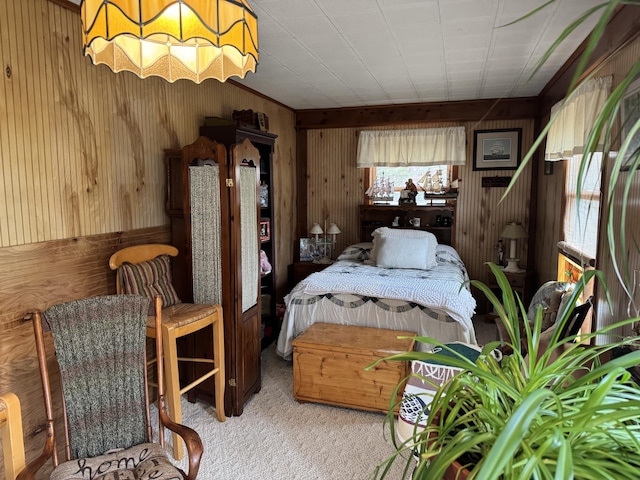 carpeted bedroom with wood walls
