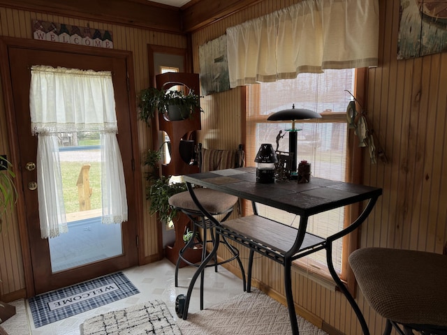 dining space featuring wood walls