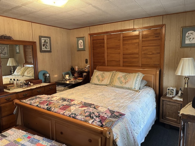 bedroom featuring wood walls