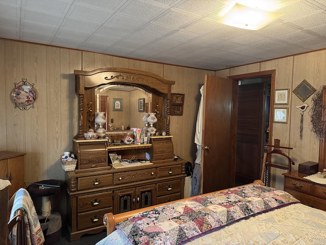 bedroom featuring wood walls