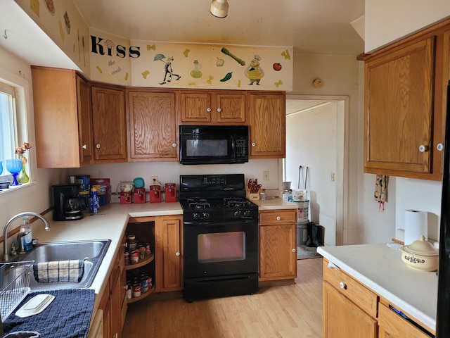 20635 Fardon St, Onaway, MI 49765 - kitchen featuring black appliances, light countertops, and a sink
