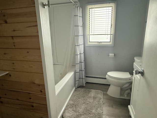 1393 Mackinaw Ave, Cheboygan, MI 49721 - full bath featuring toilet, baseboard heating, shower / tub combo with curtain, and wood finished floors