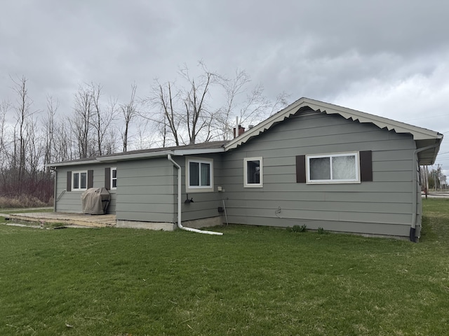 1393 Mackinaw Ave, Cheboygan, MI 49721 - back of house featuring a lawn