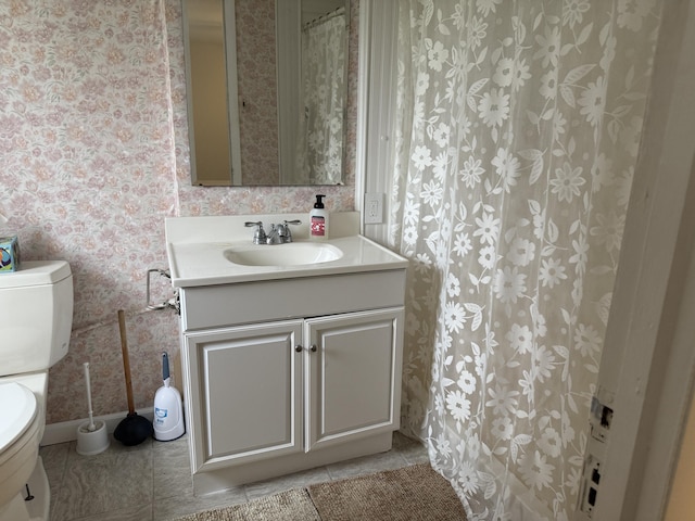 1393 Mackinaw Ave, Cheboygan, MI 49721 - full bath with tile patterned flooring, vanity, baseboards, toilet, and wallpapered walls