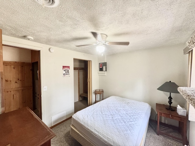 carpeted bedroom featuring ceiling fan, a closet, and baseboards