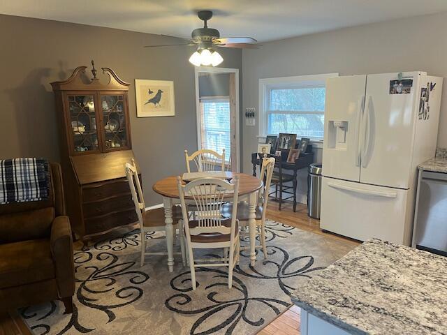 dining area featuring a ceiling fan and light wood-style flooring