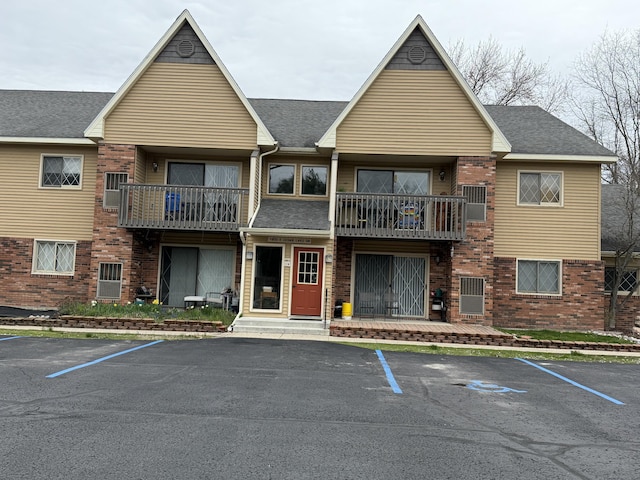 view of building exterior with uncovered parking
