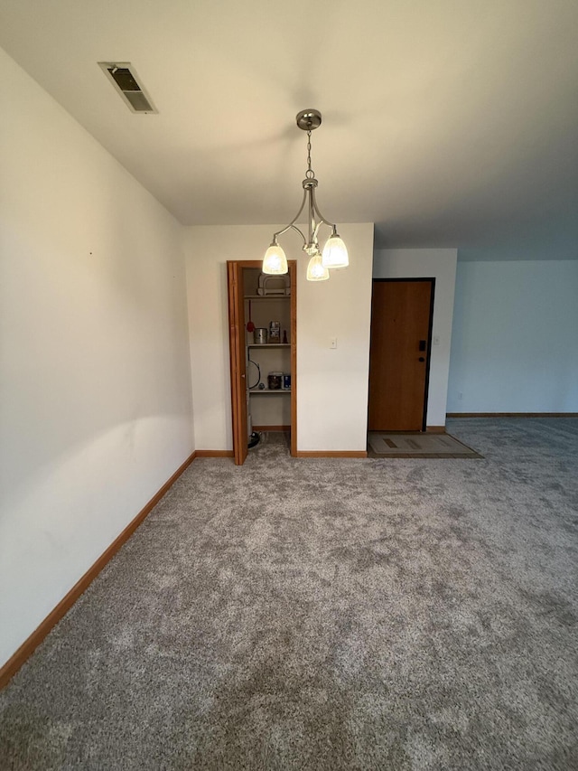 spare room featuring carpet, baseboards, and visible vents