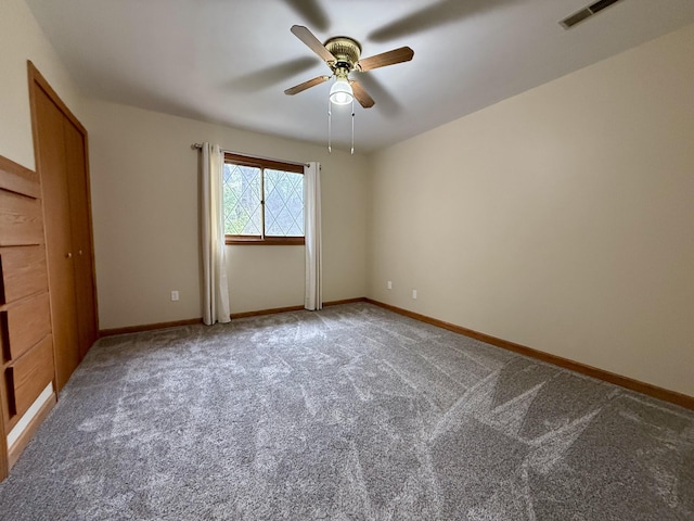 unfurnished bedroom with light colored carpet, visible vents, baseboards, and ceiling fan