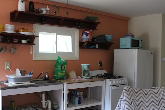 kitchen with open shelves and white appliances
