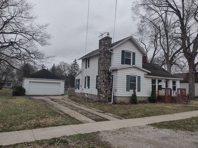 view of front facade with an outdoor structure, a garage, a chimney, and a front yard