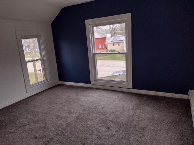additional living space with lofted ceiling, carpet flooring, and baseboards