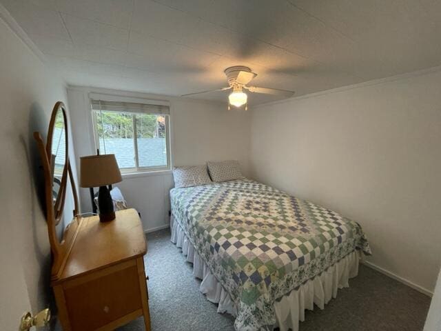 bedroom with a ceiling fan, baseboards, and carpet