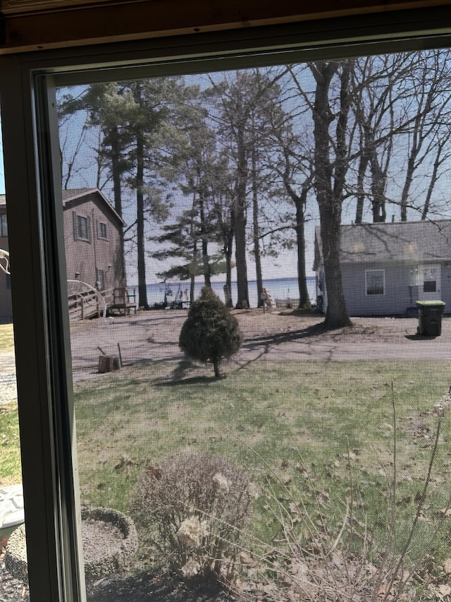 view of yard featuring a water view and fence