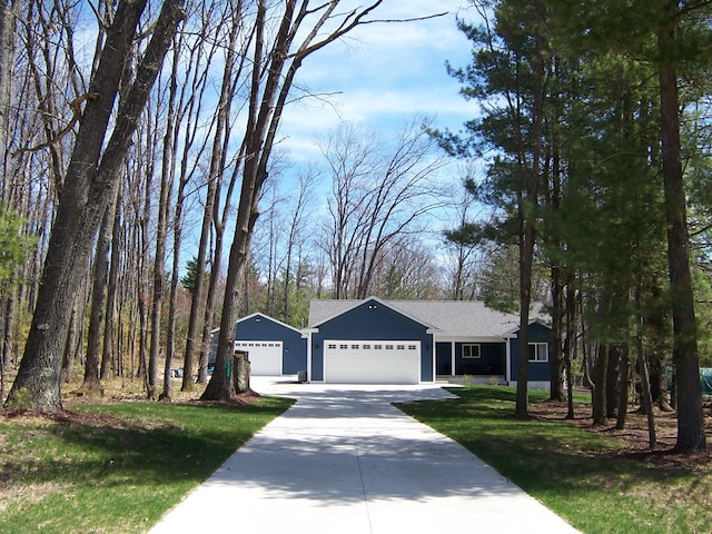 ranch-style home featuring a garage, a front yard, and driveway