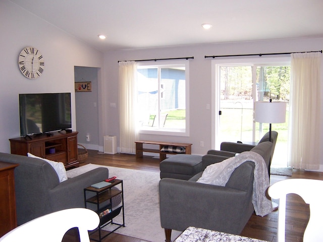 living room with lofted ceiling, recessed lighting, baseboards, and wood finished floors