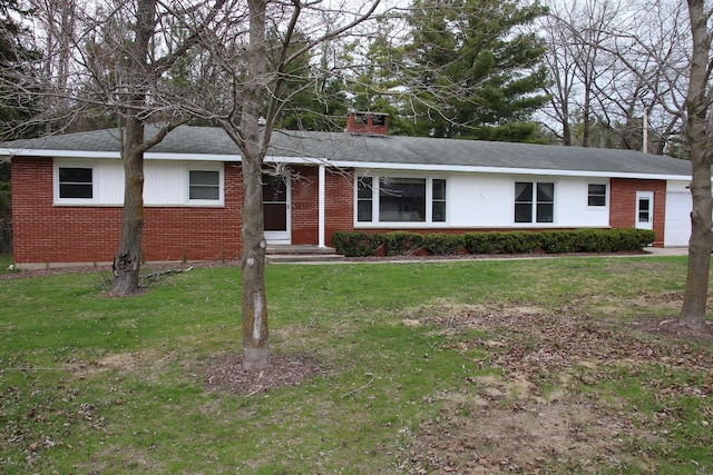 ranch-style house with brick siding, a front yard, and a chimney