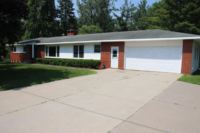 567 Long Rapids Rd, Alpena, MI 49707 - ranch-style home with brick siding, a garage, a front yard, and concrete driveway