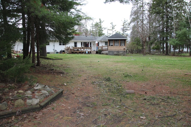567 Long Rapids Rd, Alpena, MI 49707 - rear view of property with a deck and a lawn