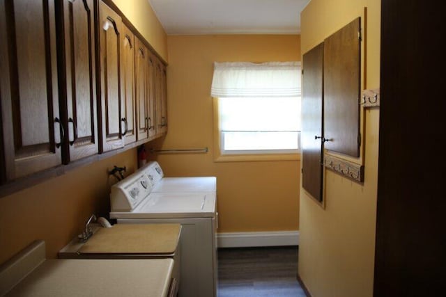 567 Long Rapids Rd, Alpena, MI 49707 - laundry room with cabinet space, washing machine and dryer, dark wood finished floors, and ornamental molding