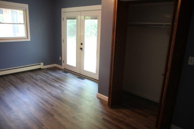 567 Long Rapids Rd, Alpena, MI 49707 - unfurnished bedroom with french doors, dark wood finished floors, a closet, baseboard heating, and access to outside