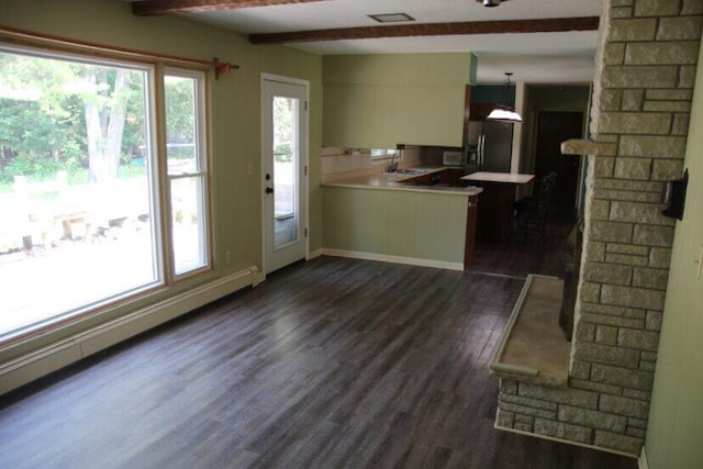 567 Long Rapids Rd, Alpena, MI 49707 - kitchen featuring refrigerator with ice dispenser, light countertops, a peninsula, dark wood-style floors, and hanging light fixtures
