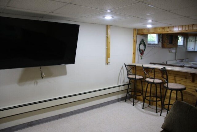567 Long Rapids Rd, Alpena, MI 49707 - indoor dry bar with a baseboard heating unit and a paneled ceiling