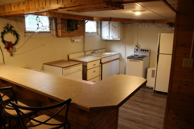 567 Long Rapids Rd, Alpena, MI 49707 - kitchen featuring white appliances, a peninsula, white cabinetry, and dark wood-style floors