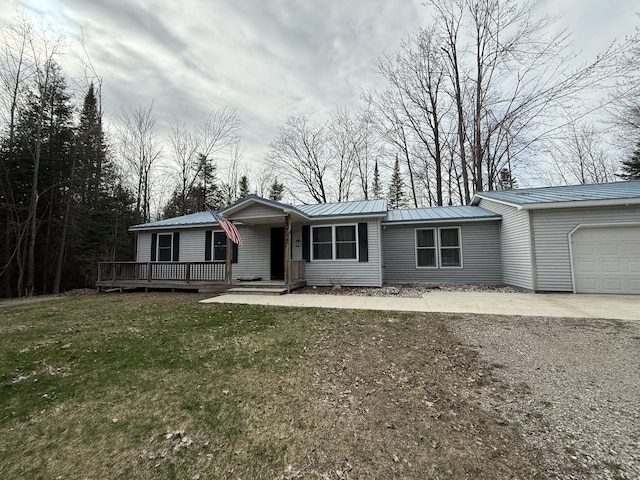 3140 Kitchen Rd, Cheboygan, MI 49721 - ranch-style house featuring an attached garage, a front yard, driveway, and metal roof