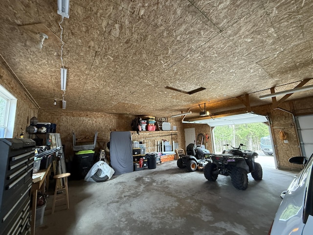 3140 Kitchen Rd, Cheboygan, MI 49721 - garage with a workshop area and a garage door opener