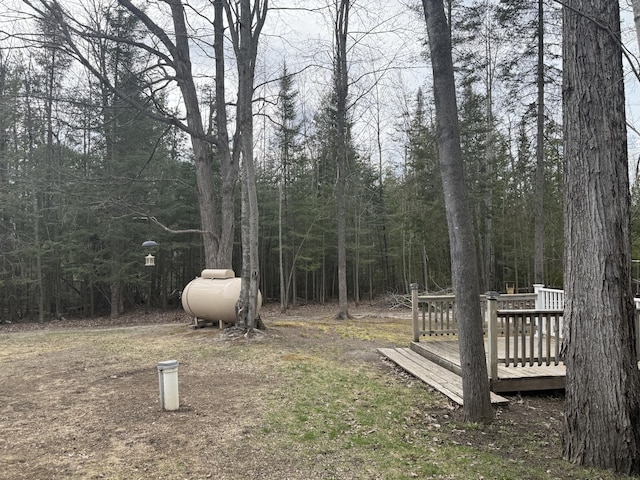 3140 Kitchen Rd, Cheboygan, MI 49721 - view of yard featuring a wooded view and a wooden deck