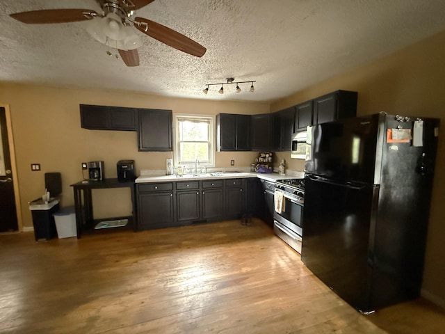 3140 Kitchen Rd, Cheboygan, MI 49721 - kitchen featuring light wood finished floors, a textured ceiling, ceiling fan, light countertops, and appliances with stainless steel finishes