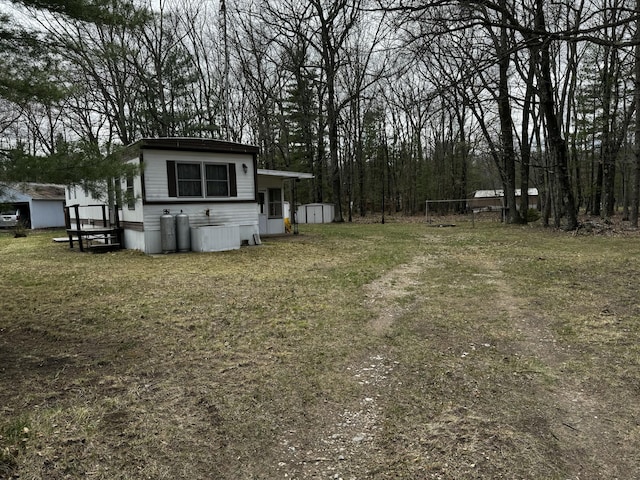 10675 N Shady Ln, Irons, MI 49644 - view of yard with a storage unit and an outbuilding