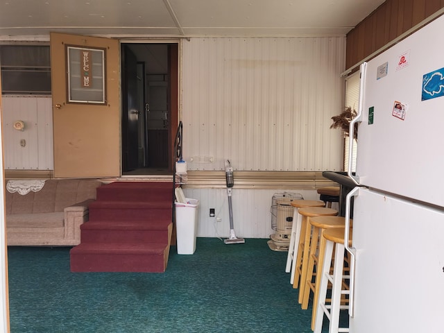 10675 N Shady Ln, Irons, MI 49644 - misc room featuring wood walls and carpet floors