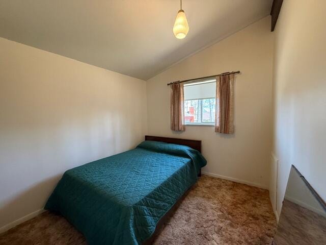 carpeted bedroom featuring vaulted ceiling and baseboards