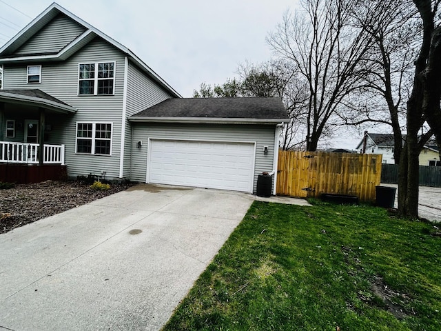view of home's exterior featuring fence, a garage, concrete driveway, and a lawn