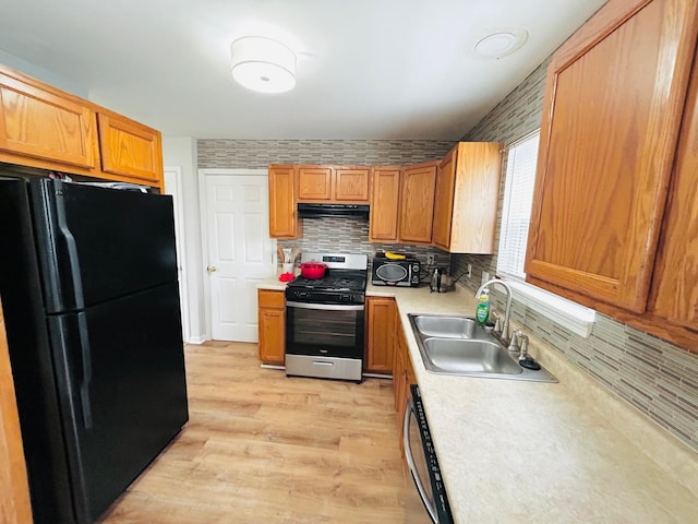 1318 9th St, Port Huron, MI 48060 - kitchen with a sink, black appliances, backsplash, light countertops, and range hood