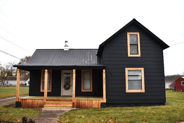 3785 S 2nd St, Onaway, MI 49765 - modern farmhouse style home featuring a porch, metal roof, and a front yard