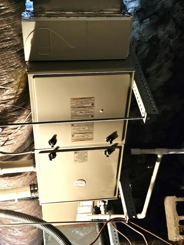 3785 S 2nd St, Onaway, MI 49765 - utility room featuring heating unit