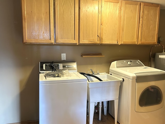 laundry area with cabinet space, independent washer and dryer, and wood finished floors