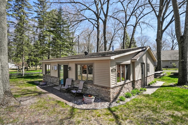 135 Alpena Trl, Houghton Lake, MI 48629 - view of property exterior featuring stone siding and a yard