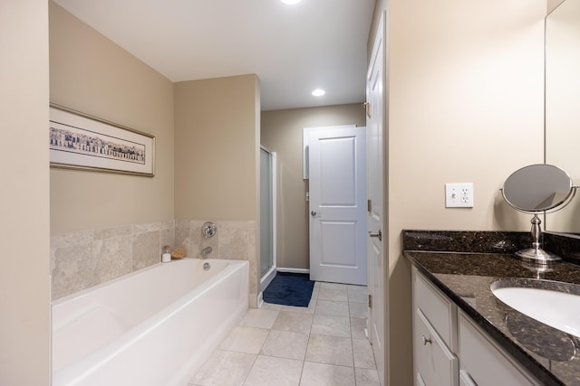 full bathroom with vanity, a shower stall, tile patterned floors, a bath, and baseboards