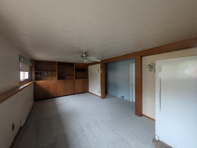 unfurnished living room with a baseboard heating unit, ceiling fan, light carpet, and baseboards