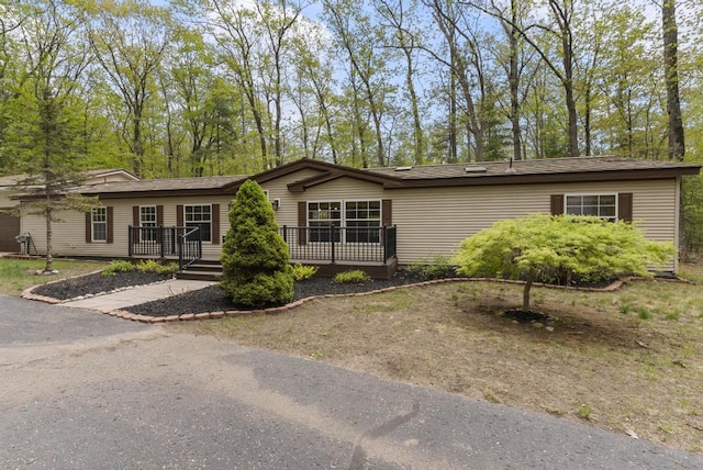 1505 Shawnee Dr, Indian River, MI 49749 - view of front facade with a wooden deck