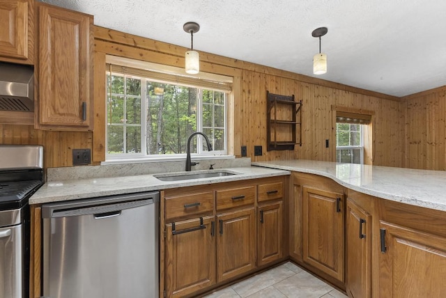 1505 Shawnee Dr, Indian River, MI 49749 - kitchen featuring stainless steel appliances, a sink, brown cabinets, and wood walls